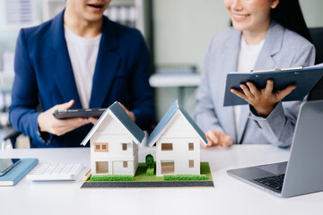 Balancing the property sector The real estate agent is explaining the house style to see the house...