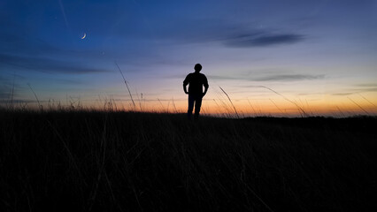 Man looking at night skies, observing celestial objects, Moon, planets, meteors.