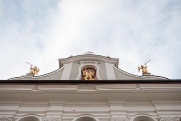 Low angle shot of gilded angel sculptures on top of a church