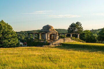 Scenic view of Water tank Hackenberg against a green field at golden hour in Vienna, Austria