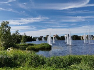 Beautiful pond with fountains in a green park in Oulu, Finland