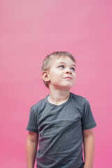 Naklejka premium Little boy smiling on pink background 