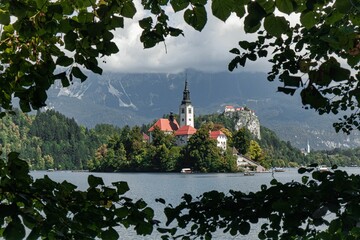 View of the historic Bled castle taken from trees across the Bled lake in Slovenia