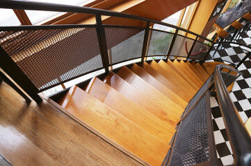 Wooden Curved Staircase Leading to Downstairs