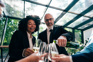 Businessmen and businesswomen making a corporate party - 781192423