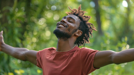 Portrait of a free happy black afro american man with open arms enjoying life in meadows and nature background , young joyful African male with good mental health
