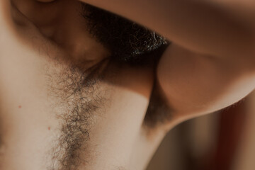 Self portrait of a man's upper body, showing his chest hair, underarm hair. The selective focus...