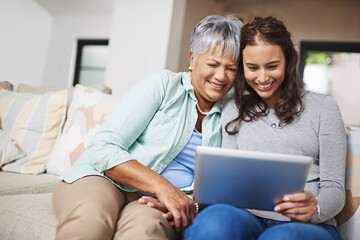 Help, tablet and woman teaching senior mother networking on internet, mobile app or website on sofa. Happy, bonding and elderly mom learning digital technology with female person in living room.