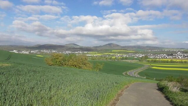 view across the Eifel in spring with yellow fields