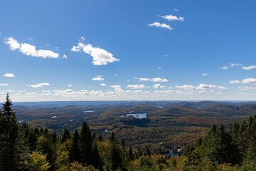 Aerial view of a vast mountain landscape under a blue sunny day