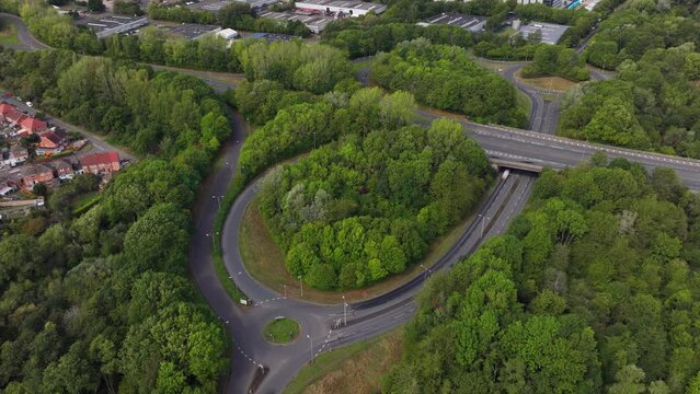 Time-lapse of a busy road junction surrounded by lush green trees