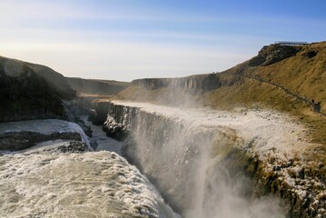 Aerial view of foamy Gullfoss Falls waterfall in Iceland under blue sky