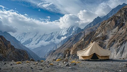 Tent in a serene mountain landscape with majestic peaks. Outdoor adventure and nature exploration