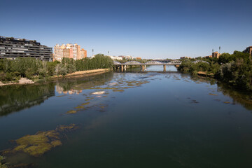 view on ebro river flowing in Zaragoza, Spain