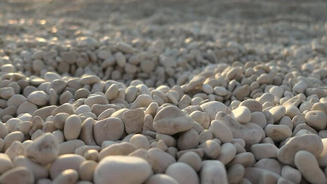 Shallow focus of sea pebbles at the beach during sunset