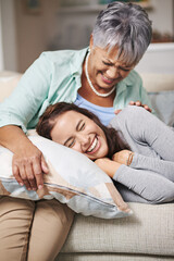 Elderly, mom and laugh with daughter on sofa with pillow for happiness in retirement for bonding...