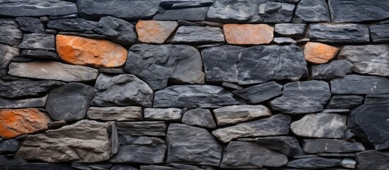 Close-up of rustic stone wall with orange hues