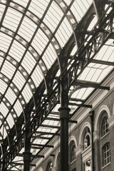 Grayscale of curving ceiling over arch facade windows at Hay's Galleria Bridge Lane, London, UK