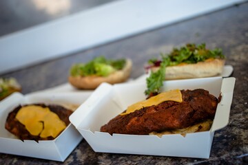 Closeup shot of a takeaway box with burger patties and cheese