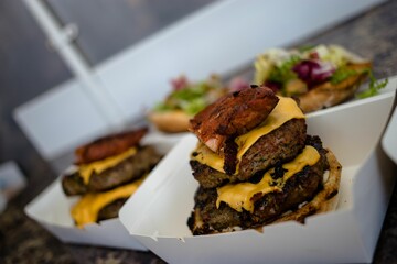 Closeup shot of a takeaway box with burger patties and cheese