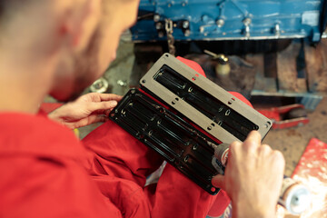 Closeup shot of a mechanic mounting the car engine