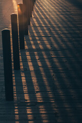 Vertical shot of columns on a pier during sunset