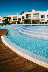 Vertical shot of an empty swimming pool in a resort area on a sunny day