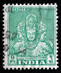 Ukraine, Kiyiv - February 3, 2024.Postage stamps from India.A post stamp printed in India shows The Trimurti - triad of deities, typically Brahma the creator, circa 1949.Philately.