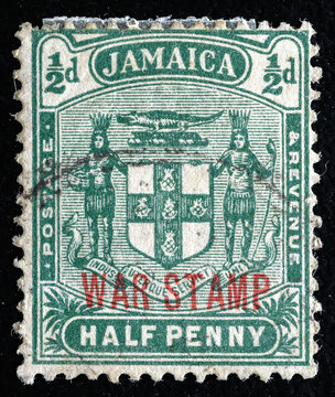 Ukraine, Kiyiv - February 3, 2024.Postage stamps from JAMAICA.An carmine postage stamp showing Arms of Jamaica. Jamaica is an island country situated in the Caribbean Sea. Philately.