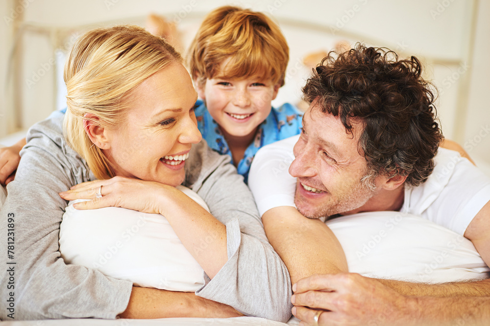 Poster Family, child and home on bed for love, embrace and bonding by having fun in the morning with pyjamas. Happy, mom and dad with kid hugging in bedroom for positive childhood memories as unity