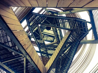 Iron staircase that makes a triangular geometric shape - great for a wallpaper - Powered by Adobe