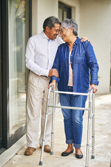 Couple, happy man and elderly woman with walker in backyard for care, love or bonding . Retirement, male pensioner and senior female person with disability for support, embrace or morning walk