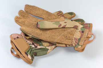 Beige tactical military gloves on a gray background - 781234619