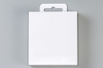 White rectangular cardboard hang tab packing box on gray surface - 781234645