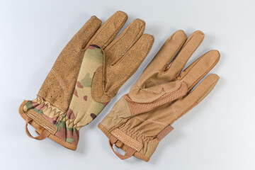 Different tactical military gloves protective color on a gray background - 781234646