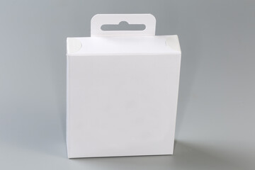 White rectangular cardboard hang tab packing box on gray surface - 781234655