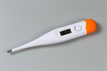 Electronic medical thermometer on a gray surface