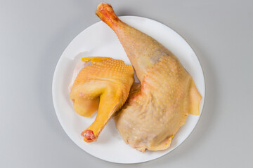 Raw chicken pieces on dish on gray background, top view © An-T