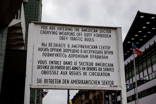 Historical text sign at the Checkpoint Charlie as a border of east and west Berlin, Germany.