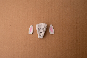 a close up of a crafted sheep head, part of making process, made from paper egg box, top view,...