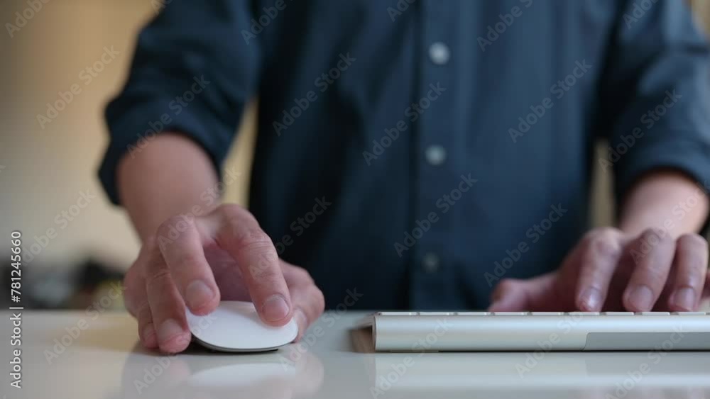 Poster hand using computer mouse working on table in modern office