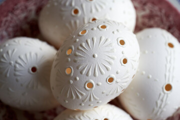 White Easter eggs decorated with wax with drilled holes, closeup - 781246471