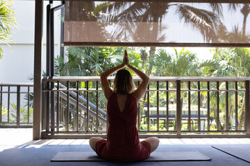 yoga retreat in Thailand or Bali, woman practices yoga and mindfulness meditation - 781247838