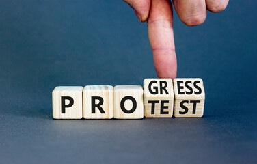 Progress vs protest symbol. Concept word Progress Protest on beautiful wooden cubes. Beautiful grey...