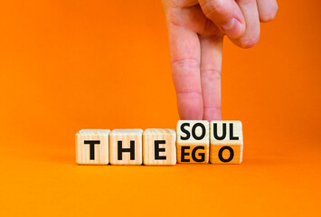 Soul or ego symbol. Concept word The soul or The ego on beautiful wooden cubes. Beautiful orange table orange background. Psychologist hand. Psychological soul or ego concept. Copy space. - obrazy, fototapety, plakaty