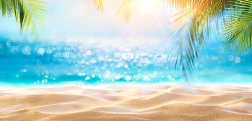 Fototapeta na wymiar Beach Holiday - Sand And Defocused Palm Leaves In Sunny Abstract Seascape With Glittering In Ocean