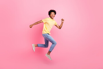 Fototapeta na wymiar Full length portrait of overjoyed energetic person jumping rush isolated on pink color background