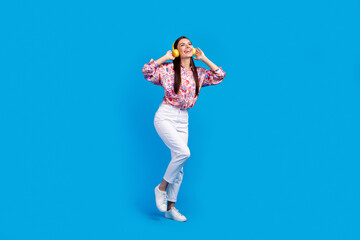 Full length photo of carefree funky lady dressed print blouse dancing enjoying songs headphones...
