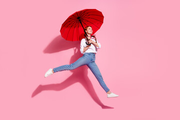Full length photo of cute adoranle lady dressed cowboy outfit jumping walking holding umbrella emtpy space isolated pink color background