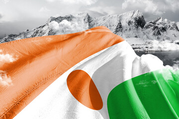 Niger national flag cloth fabric waving on beautiful ice Mountain Background. - obrazy, fototapety, plakaty